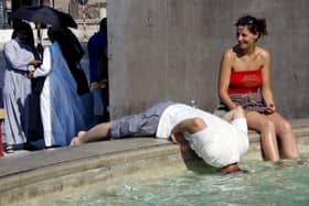 Tourists refresh themselves in the water of a fountain in downtown Rome in 2005 (Photo: VINCENZO PINTO/AFP via Getty Images)