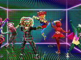Five Masked Dancers - Sea Slug, Pig, Pearly King, Onomatopoeia, Tomato Sauce and Cactus - pose on an electric green soundstage (Credit: ITV)