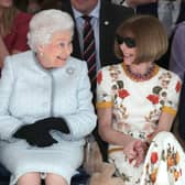 LONDON, ENGLAND - FEBRUARY 20:  Queen Elizabeth II sits next to Anna Wintour as they view Richard Quinn’s runway show before presenting him with the inaugural Queen Elizabeth II Award for British Design as she visits London Fashion Week’s BFC Show Space on February 20, 2018 in London, United Kingdom. (Photo by Yui Mok - Pool/Getty Images)