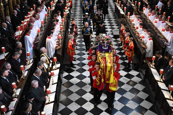 Soldiers of The Queen’s Company of the Grenadier Guards carry the coffin of Queen Elizabeth II