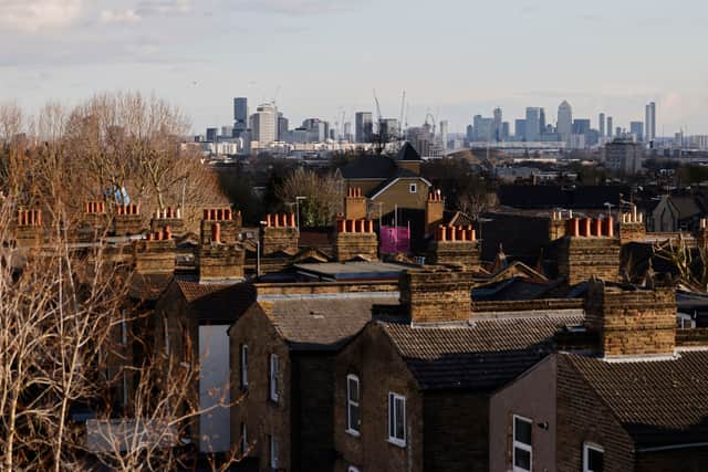 A view of the back of residential properties with the skyline of London’s financial district seen behind taken in Walthamstow in London.