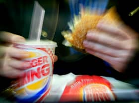  A man eats his lunch at a Burger King restaurant.