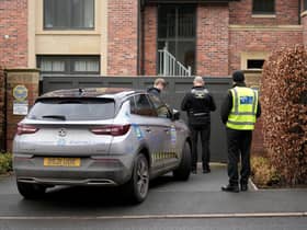 Police officers standing outside Mason Greenwood’s house in February 2022.