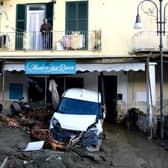 A man looks out from the balcony of his home in Casamicciola on November 27, 2022, following heavy rains that caused a landslide on the island of Ischia, southern Italy. - Italian rescuers were searching for a dozen missing people on the southern island of Ischia after a landslide killed at least one person, as the government scheduled an emergency meeting. A wave of mud and debris swept through the small town of Casamicciola Terme early Saturday morning, engulfing at least one house and sweeping cars down to the sea, local media and emergency services said. (Photo by Eliano IMPERATO / AFP) (Photo by ELIANO IMPERATO/AFP via Getty Images)