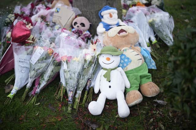 Among the floral tributes at Babbs Mill Lake were teddies and Snowman toys.
