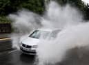 A car drives through floodwater (Photo by Matthew Horwood/Getty Images)