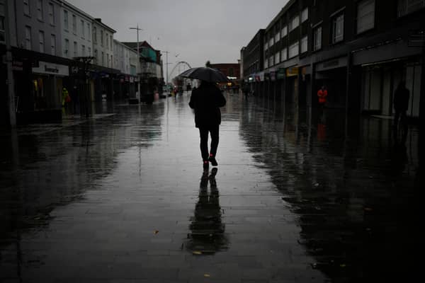 Dismal weather heralds the arrival of the UK Chancellor’s Autumn Statement as people shop in the centre of Bolton.