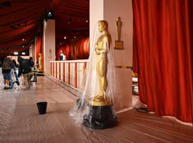 A bucket collects water leaking from the ceiling as rain from a winter storm falls on the not so red carpet arrivals area, ahead of the 95th Academy Awards, in Hollywood, California, on March 10, 2023.