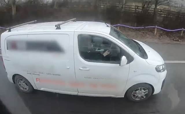 Motorists caught on camera watching a film while driving
