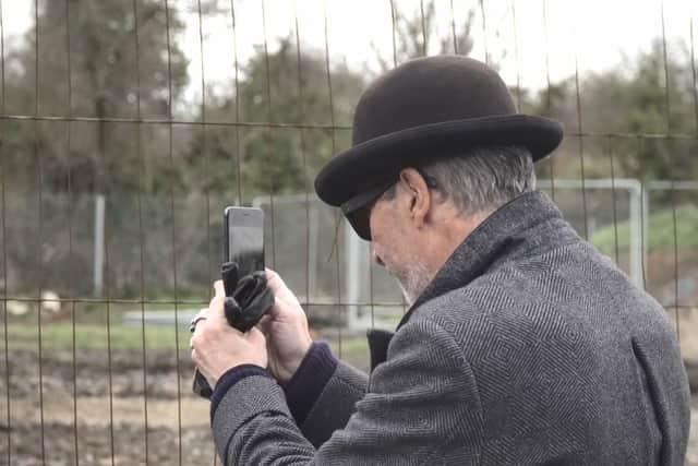 A mystery man in a bowler hat has been seen scoping out a famous site where the illusive artist Banksy left a mural that was inadvertently torn down by builders