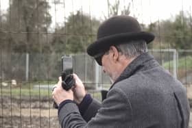 A mystery man in a bowler hat has been seen scoping out a famous site where the illusive artist Banksy left a mural that was inadvertently torn down by builders