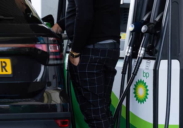 A customer uses a fuel pump on a BP Plc petrol station forecourt in London, UK (Photographer: Chris Ratcliffe/Bloomberg via Getty Images)