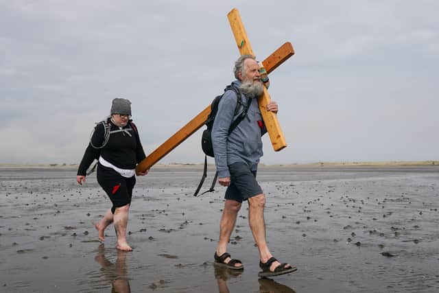 Pilgrims celebrate Easter by carrying wooden crosses as they walk over the tidal causeway to Lindisfarne during the final leg of their annual Good Friday pilgrimage.