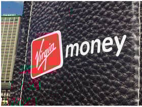 British entrepreneur Richard Branson walks out of a giant wallet as he launches Virgin Money's new credit cards in Sydney Harbour on July 27, 2010. The financial services arm of Branson's Virgin Group now offers Australians low interest rate credit cards, savings accounts, superannuation and car insurance. AFP PHOTO / Torsten BLACKWOOD (Photo by TORSTEN BLACKWOOD / AFP) (Photo by TORSTEN BLACKWOOD/AFP via Getty Images)
