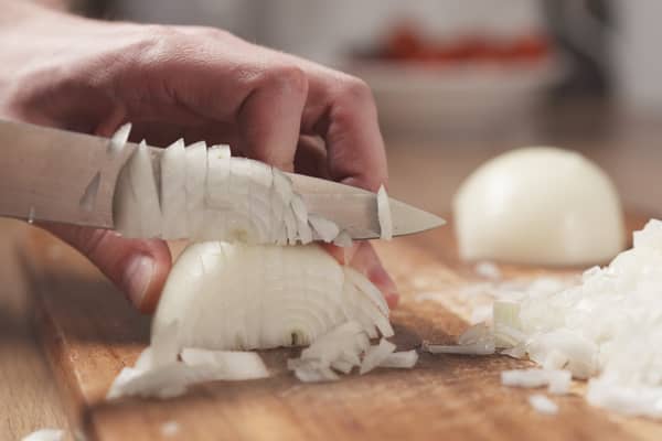 Putting a wet paper towel next to the chopping board supposedly helps stop your eyes from watering (Photo: Adobe)