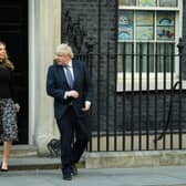 Prime Minister Boris Johnson and his partner Carrie Symonds stand outside the door of number 10 Downing Street (Photo by Leon Neal/Getty Images)