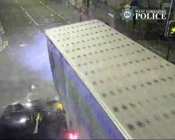 The car is seen smashing into the lorry.