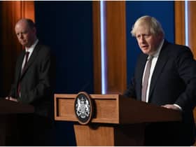 LONDON, ENGLAND - NOVEMBER 15: Prime Minister Boris Johnson standing next to British Chief Medical Officer for England Chris Whitty as he addresses the media regarding the United Kingdom's Covid-19 infection rate and vaccination campaign at Downing Street Briefing Room on November 15, 2021 in London, England. The prime minister and his advisers encouraged Britons to receive their Covid-19 vaccine booster when eligible. (Photo by Leon Neal - WPA Pool/Getty Images)