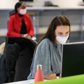 Students, wearing face masks to help mitigate the spread of coronavirus COVID-19, work on computers in the Social Learning Zone at the University of Bolton (Photo by OLI SCARFF / AFP) (Photo by OLI SCARFF/AFP via Getty Images)