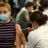 A woman receives a vaccine at the Chelsea F.C. pop up vaccine hub (Photo: Hollie Adams/Getty Images)