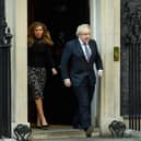 Prime Minister Boris Johnson and his partner Carrie Symonds stand outside the door of number 10 Downing Street (Photo by Leon Neal/Getty Images)