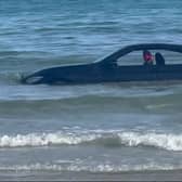 A convertable BMW was washed out to see after parking on a beach in Cornwall