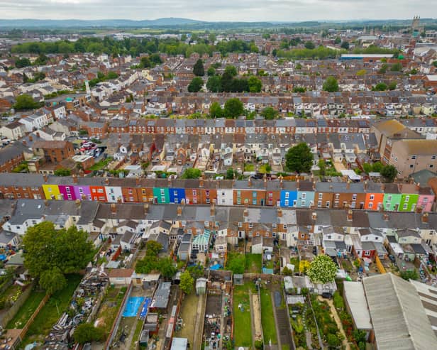 Tasha Frootko and partner Stuart Doust have transformed a street by painting the houses bright colours in Gloucester.