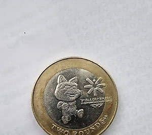 The £2 coin features the official mascot of the games, Tosha the Cat, as well as the logo of the games.