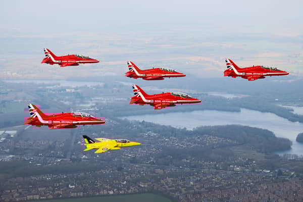 The Red Arrows fly alongside a Yellow Jack