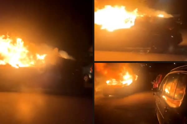 Man finds a car engulfed in flames rolling backwards down street.