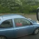 Woman applies make-up while driving along the motorway.