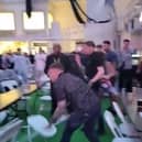 Men can be seen throwing chairs across the room at the Winter Gardens first Euros Fanzone match. 