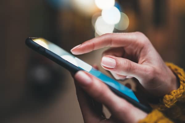 Woman scrolls on a mobile phone.  Photo: A_B_C - stock.adobe.com