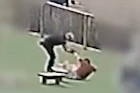 Still from footage of William Kevin Clifford subjecting 11-year-old Tobie Orlowski to a sustained attack in which he pushed the schoolboy to the ground multiple times in the grounds of Tettenhall Wood School in Wolverhampton. 
