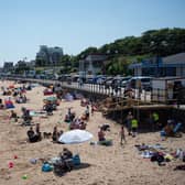 Members of the public relax on the beach in hot weather in Cleethorpes, north east England.