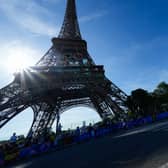 Spectators react as competitors run passed the Eiffel Tower during the Olympic Games Paris 2024. Photo: Rebecca Blackwell - Pool/Getty Images