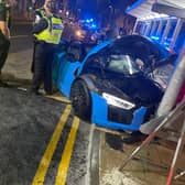 A light blue Audi R8 supercar hit a street post. 