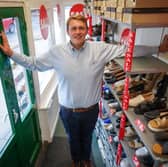 Oliver Salter, 31, who owns Peter Scott shoe shop in Woodhall Spa, Lincolnshire, Britain's smallest shoe shop.