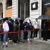 People queue in the rain at an Apple Store in Paris. Photo: MIGUEL MEDINA/AFP via Getty Images