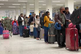 Passengers queue for check in at Manchester Airport's Terminal 1.