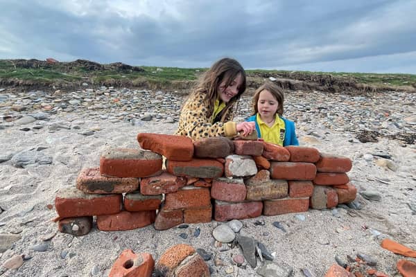 Heidi and Thea on the beach on Holy Island. Meet the family who live on an island that can only be accessed twice a day and only has five children in the local school. 