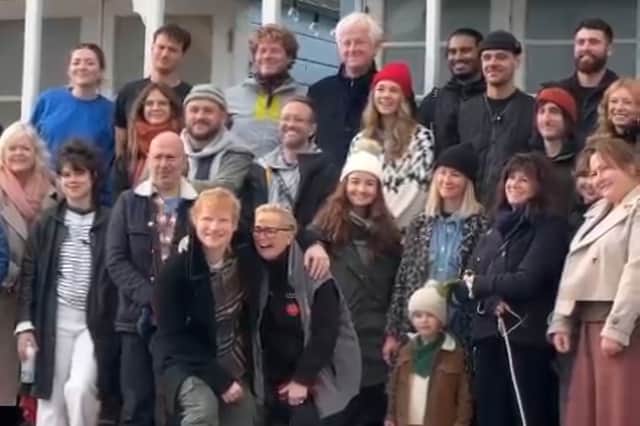 The cast and crew pose for a photo at the end of filming
