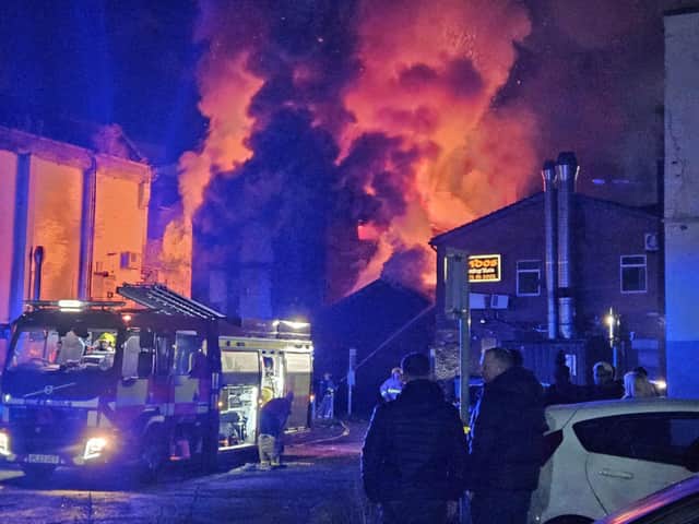 Firefighters tackling a huge fire at an abandoned building behind letting agency Open House and Aliz takeaway on Church Street, Preston