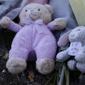 Flowers and stuffed toys are left as tributes to 'Baby A'.