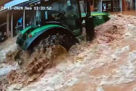 CCTV captures a tractor driving fast through floodwater in Tenbury Wells, Worcestershire.