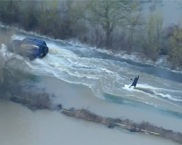 Man wakeboards along flooded road in Leicestershire.