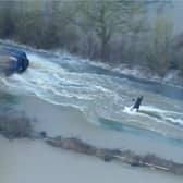 Man wakeboards along flooded road in Leicestershire.