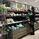 An employee stacks shelves at a Waitrose supermarket (Photo: HOLLIE ADAMS/AFP via Getty Images)