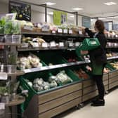 An employee stacks shelves at a Waitrose supermarket (Photo: HOLLIE ADAMS/AFP via Getty Images)