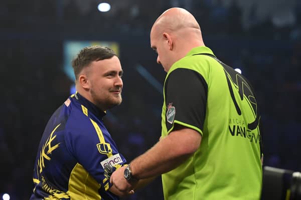 Luke Littler congratulates Michael van Gerwen on his victory during the opening night of the Premier League Darts season at The SSE Arena Belfast